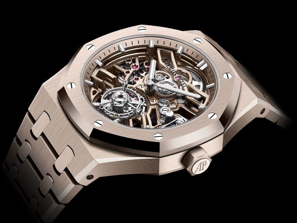 A luxurious watch with a skeletonized dial showcasing intricate inner mechanics and gears, featuring the brand name Audemars Piguet on the face.