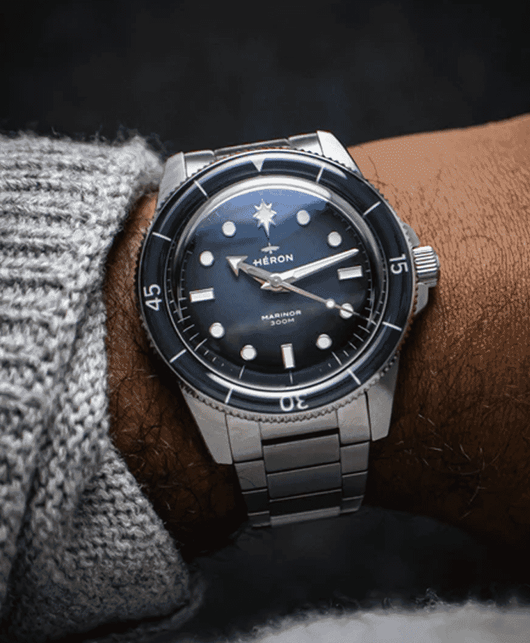A sleek, modern microbrand dive watch with a deep blue dial, bold luminous markers, and a stainless steel bracelet, designed for affordability and collector interest in 2026.